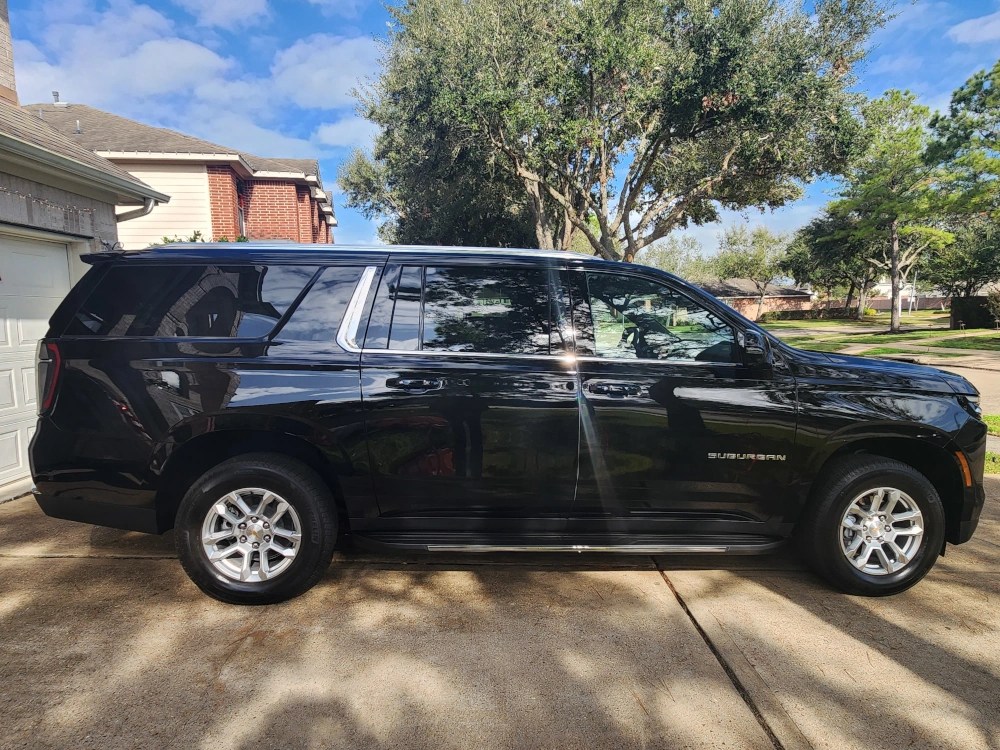 A black limousine seen from the side.